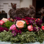 Taxidermied rabbit body on a flowered centerpiece